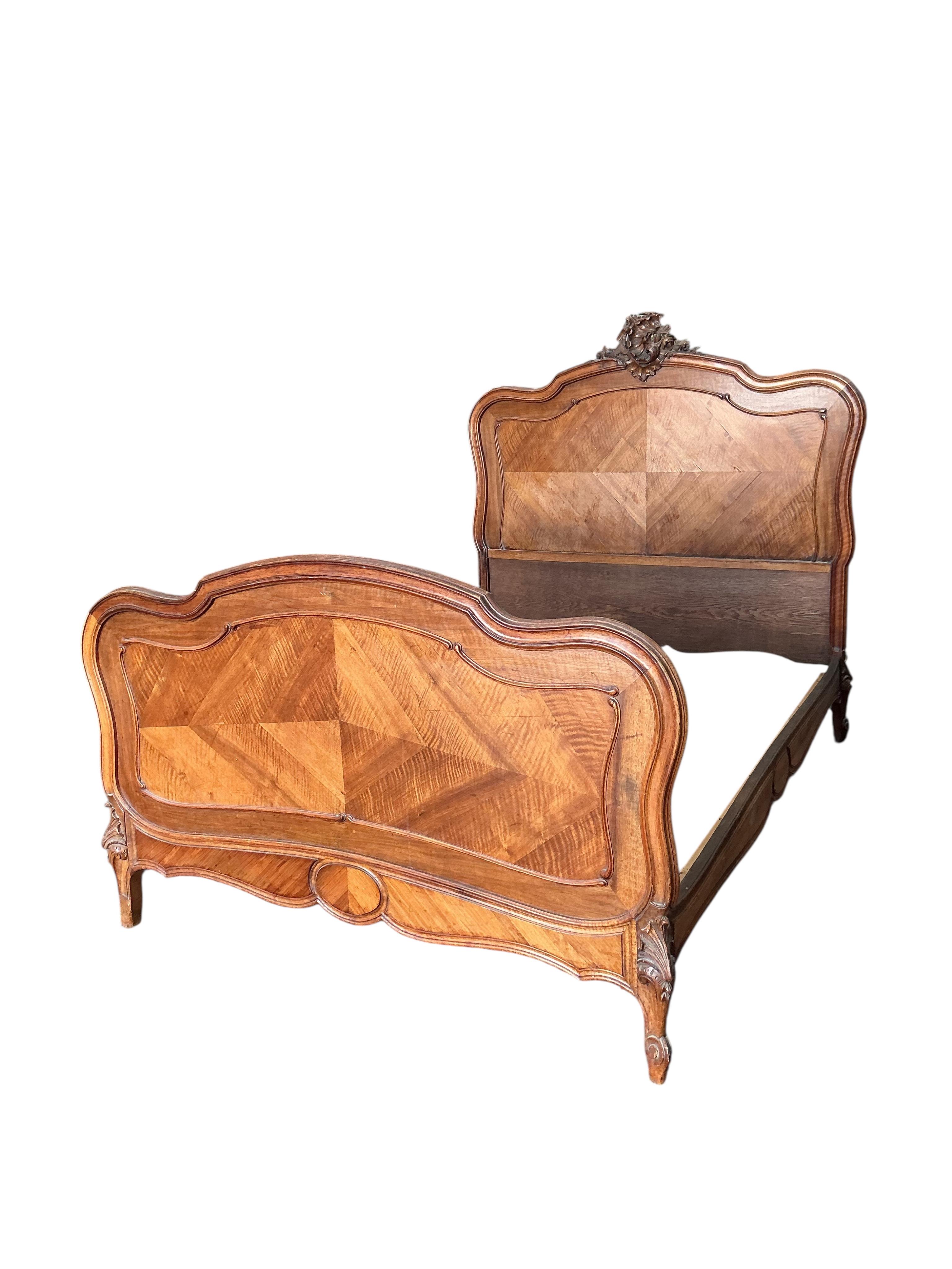 An early 20th century French carved walnut bedframe, length 200cm, width 144cm, height 150cm